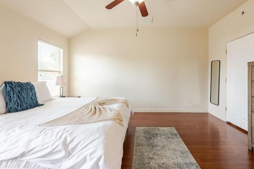 a white bedroom with a bed and a ceiling fan at Gorgeous 2story Home with 4 bedrooms in Buda