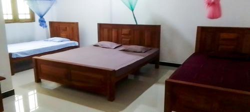 a bedroom with two beds in a room at Igloo Tourist Homestay Anuradhapura in Anuradhapura