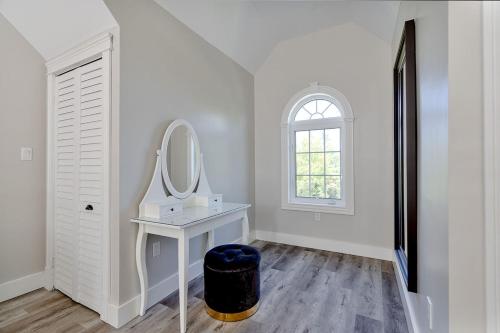 a white room with a vanity and a mirror at The Montgomery in Cavendish