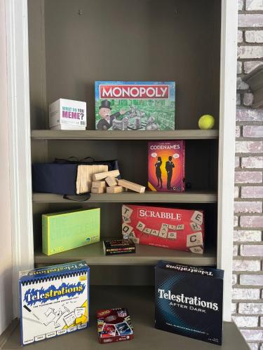 a book shelf filled with games and books at Mariposa home, Yosemite retreat, deer watching, family friendly in Mariposa