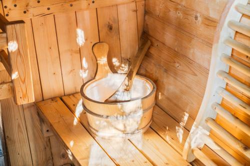 a sauna with a wooden spoon in a bucket at Hideaway Hot Tub Sunna Lake Kayaks Pool in Bushkill