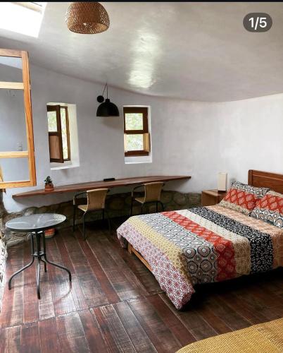 a bedroom with a bed and a table and chairs at YakuRumi Tipis & Glamping in Caraz