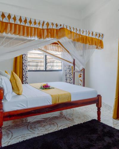 a bedroom with a bed with a canopy at jahazi homes -watamu in Watamu