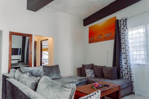 a living room with a couch and a table at jahazi homes -watamu in Watamu