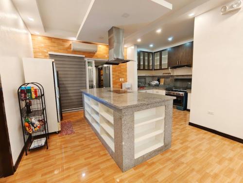 a kitchen with a island in the middle of a room at m4 Private Villa in Angeles