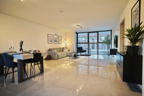 a large living room with a table and a couch at Chic Loft Facing Neo-Gothic Church in Ghent