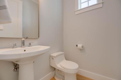 a white bathroom with a sink and a toilet at Sea Glass Cove by SoFLA Vacations in Marathon