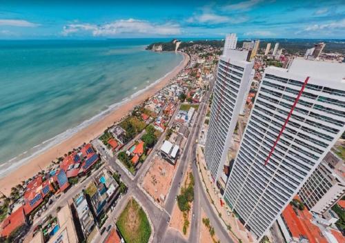 an aerial view of a beach and buildings at Apartamento Varandinha Mar Ponta Negra 2 Quartos para 4 pessoas in Natal