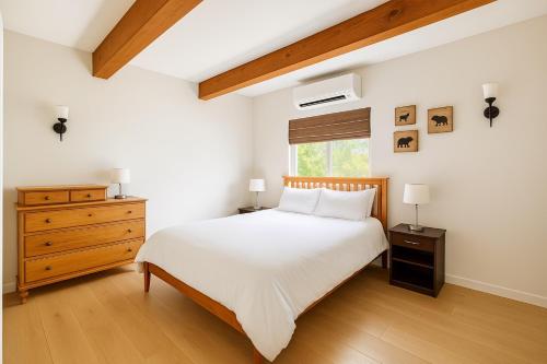 a bedroom with a bed and a dresser and a window at Welcome to The Village Hideout, Steps to the Village, Resort, Golf, SHARC, AC, Hot-tub, Grill and Bikes in Sunriver
