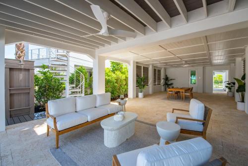 a living room with a couch and chairs and a table at Sea Glass Cove by SoFLA Vacations in Marathon