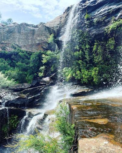 a waterfall on the side of a mountain at 'Bulli Escape' Bright Beachfront Stay & Scenic Views in Bulli