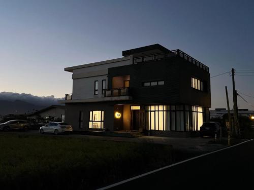 a black house with a car parked in front of it at Nam San Private Villa in Zhuangwei