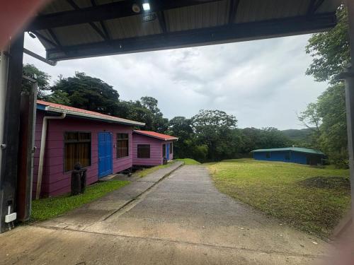 two small buildings sitting next to a dirt road at The La Casa de Rum & Drum - Suite A in Monteverde Costa Rica