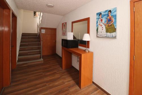 a room with a hallway with a staircase and a mirror at Hotel Casa Frida in Cuernavaca