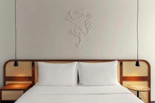 a bed with two white pillows in a room at The Isolano, Adults Friendly Resort, Autograph Collection - 12years and above in Cres