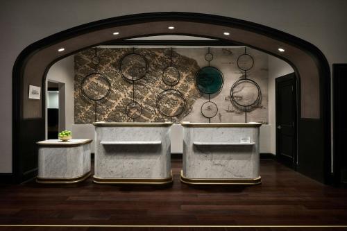 a kitchen with a wall with pots and pans at Renaissance Portsmouth-Norfolk Waterfront Hotel in Portsmouth