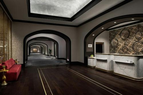 a hallway with a red couch and an archway at Renaissance Portsmouth-Norfolk Waterfront Hotel in Portsmouth