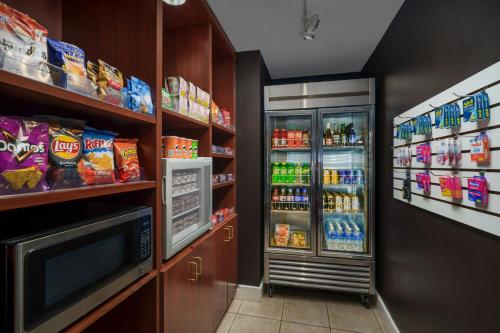 a grocery store aisle with a refrigerator and a television at Courtyard by Marriott Potomac Mills Woodbridge in Woodbridge