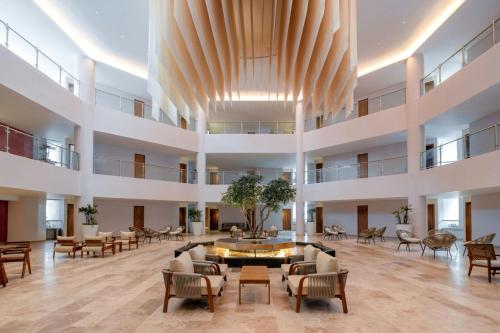 a large lobby with chairs and a table in a building at Almare, a Luxury Collection Resort, Isla Mujeres, Adult All-Inclusive in Isla Mujeres
