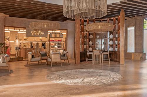a room with chairs and tables and chandeliers at Almare, a Luxury Collection Resort, Isla Mujeres, Adult All-Inclusive in Isla Mujeres