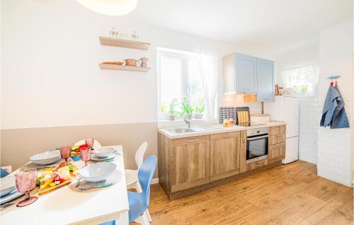 a kitchen with a table and a counter top at Cozy Home In Klimno With Wifi in Klimno