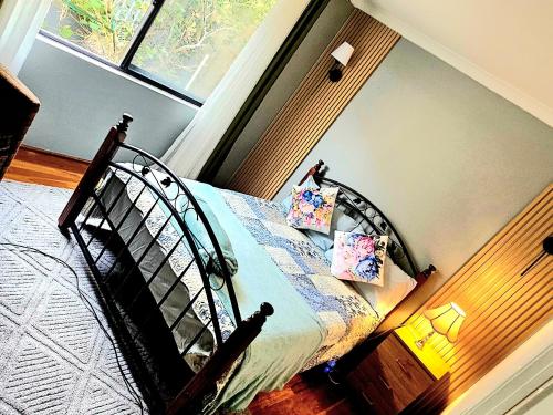 a bedroom with a bed and a window at Joyful living Guest Suite in Coogee