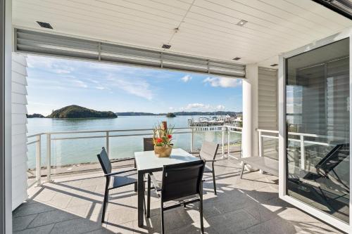 a dining room with a view of the water at Beach Front 2 Bedroom Apartment in Paihia