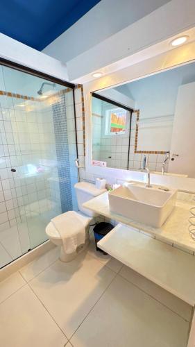 a bathroom with a sink and a toilet and a shower at Villa Baobá Pousada & Spa in Búzios