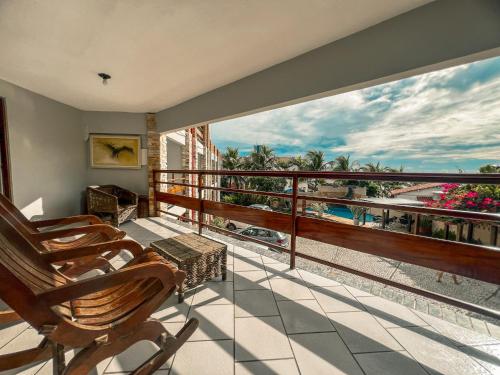 a balcony with chairs and a view of the ocean at Falésia Praia Hotel in Canoa Quebrada
