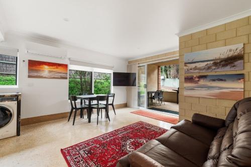 a living room with a couch and a table at Arcadia Dreaming Chalet Margaret River in Margaret River Town