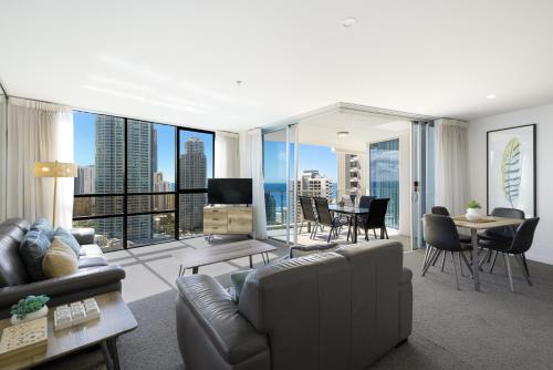 a living room with a couch and a table at Artique Surfers Paradise - Official in Gold Coast