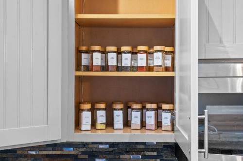 a cupboard with bottles of oils in it at Hideaway Hot Tub Sunna Lake Kayaks Pool in Bushkill