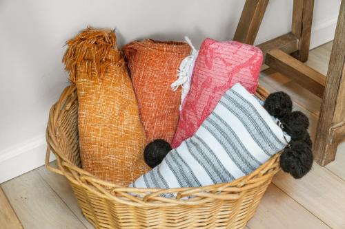 a basket filled with towels on a floor at Hideaway Hot Tub Sunna Lake Kayaks Pool in Bushkill
