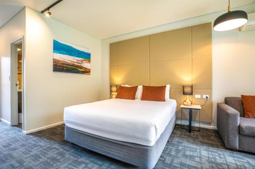 a hotel room with a bed and a couch at Nightcap at York on Lilydale in Mount Evelyn