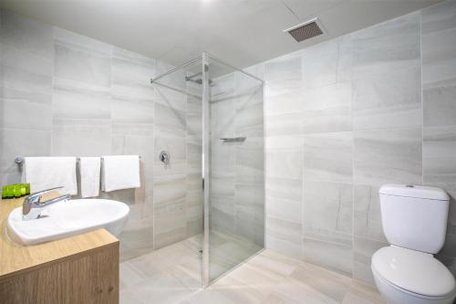 a bathroom with a shower and a toilet and a sink at Nightcap at York on Lilydale in Mount Evelyn