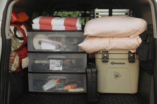 a van with its doors open withartmentsysical at Hawaiian Overlanders in Kailua-Kona