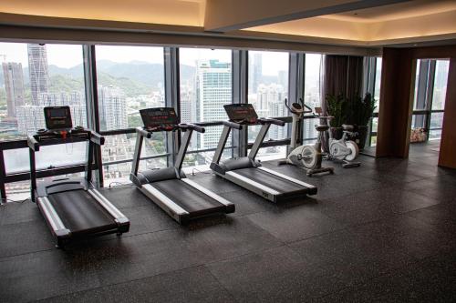 a gym with cardio equipment in a building at Huaqiang Plaza Hotel Shenzhen, Enjoy Complimentary Mini Bar & Night Snack, Add breakfast - enjoy complimentary afternoon tea in Shenzhen