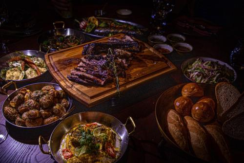 a table with many different types of food on it at SOMA HOTEL Riverside in Phnom Penh