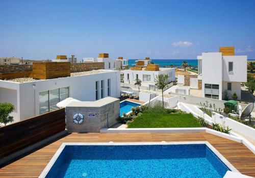a view of a villa with a swimming pool at Luxury Cyprus Villa Indigo Villa Private Pool Sea View 1 Bdr Paphos in Paphos