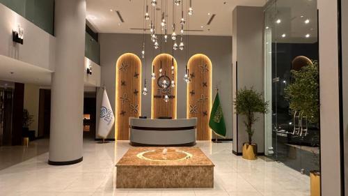 a lobby with a clock in the middle of a building at فندق فيوري - المطار in Taif