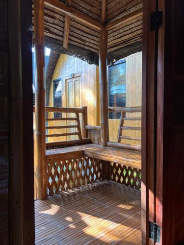 a porch of a house with wooden walls and windows at L Cafe Restobar & Lyn's Guest House in San Juan