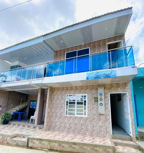 a building with a balcony on top of it at Hostal marazulcapurgana in Capurganá
