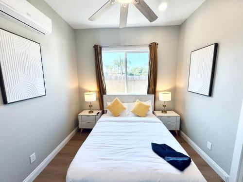 a bedroom with two beds and two lamps and a window at Exotic Home Escondido by sdstay in Escondido