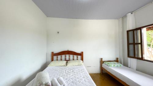 a bedroom with two beds and a window at Império hospedagem in Sao Jorge