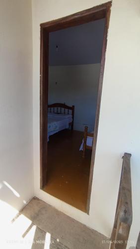 a mirror in a room with a bed in it at Império hospedagem in Sao Jorge