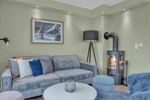 a living room with a couch and a fireplace at Haus-Alster in Westerland (Sylt)