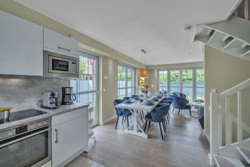 a kitchen and dining room with a table and chairs at Haus-Alster in Westerland (Sylt)