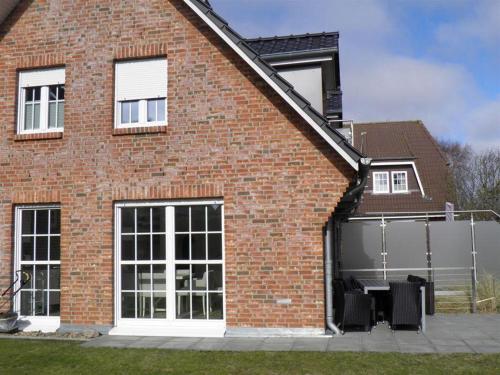 a brick house with white doors and windows at Haus-Alster in Westerland (Sylt)