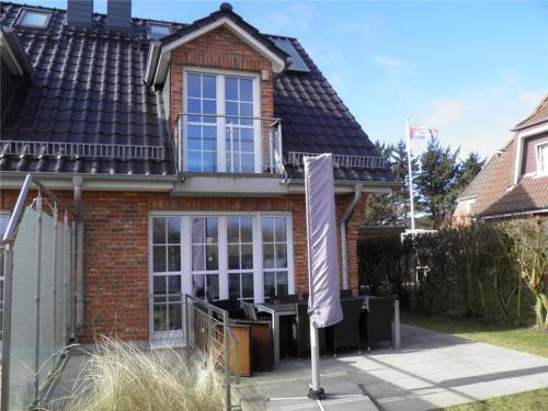 a brick house with a sign in front of it at Haus-Alster-2 in Westerland (Sylt)