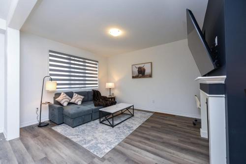 a living room with a couch and a tv at Spacious 4br25ba Retreat W King Beds, Desk, Dt in Milton